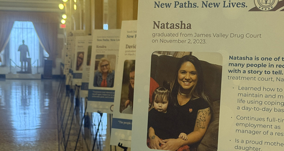 Photo of treatment court graduate posters in a hallway in the State Capitol in Pierre. 